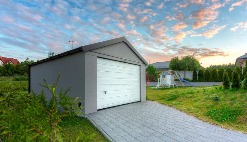 Free standing garage in the garden at sunset