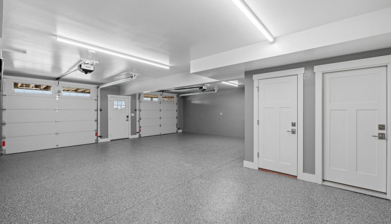 Interior view of an empty garage with a metallic surface floor a